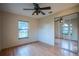 Bedroom includes a ceiling fan, window and mirrored closet doors at 1255 Ne 70Th St, Ocala, FL 34479