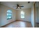 Bedroom with wood floor, window, a ceiling fan and closet with mirrored sliding doors at 1255 Ne 70Th St, Ocala, FL 34479