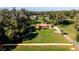 A beautiful home with a red metal roof surrounded by green lawn, mature trees, and other foliage at 1255 Ne 70Th St, Ocala, FL 34479