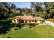 Expansive aerial view of a beautiful single-story home with a red tile roof and lush green lawn at 1255 Ne 70Th St, Ocala, FL 34479