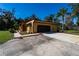 Angle view of exterior elevation of ranch-style home with two car garage and large paved driveway at 1255 Ne 70Th St, Ocala, FL 34479