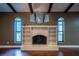 Living room fireplace with built-in shelving and window views at 1255 Ne 70Th St, Ocala, FL 34479