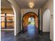 View of a spacious foyer with arched doorways and decorative lighting fixtures at 1255 Ne 70Th St, Ocala, FL 34479