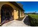 Side view of the front entrance featuring an ornate wrought iron gate and well-maintained landscaping at 1255 Ne 70Th St, Ocala, FL 34479