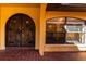 A close-up of the front entrance shows detailed tile work and a unique wooden door with iron accents at 1255 Ne 70Th St, Ocala, FL 34479