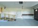 Bright garage featuring a ramp to interior door, workbench, and overhead door with windows at 1255 Ne 70Th St, Ocala, FL 34479