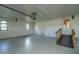 Clean, bright garage with ramp to the exterior door, two windows, and concrete flooring at 1255 Ne 70Th St, Ocala, FL 34479
