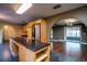 Well-lit kitchen with stainless steel appliances, dark countertops, tile floors, and open access to other rooms at 1255 Ne 70Th St, Ocala, FL 34479