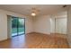 Bright living room features wood floors, a ceiling fan, sliding glass door and access to the back yard at 1255 Ne 70Th St, Ocala, FL 34479