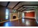 Bright living room with a fireplace, wood beam ceilings, and hardwood floors at 1255 Ne 70Th St, Ocala, FL 34479