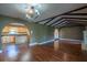 Open concept living space featuring hardwood floors, wood beams, a chandelier, and arched doorways at 1255 Ne 70Th St, Ocala, FL 34479