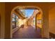 View of a large, arched outdoor patio with red tile flooring and a spiral staircase at 1255 Ne 70Th St, Ocala, FL 34479