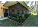 View of the screened-in patio and landscaping at 1255 Ne 70Th St, Ocala, FL 34479