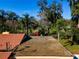 Close aerial view of a flat roof section with a tar and pebble topping next to an orange roof at 1255 Ne 70Th St, Ocala, FL 34479