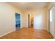Spacious room shows an entry down to the basement as well as access to the utility room at 1255 Ne 70Th St, Ocala, FL 34479