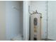 Utility area with hot water tank and tiled shower stall, all in need of repair at 1255 Ne 70Th St, Ocala, FL 34479