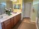 Bathroom features a double sink vanity with granite countertops and tile floors at 12752 Se 91St Terrace Rd, Summerfield, FL 34491