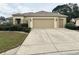 Charming single-story home with a well-manicured front yard and a spacious two-car garage at 12752 Se 91St Terrace Rd, Summerfield, FL 34491