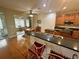 Open kitchen featuring hardwood floors, breakfast bar, and stainless steel appliances at 12752 Se 91St Terrace Rd, Summerfield, FL 34491