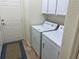 Bright laundry room features a white washer and dryer and cabinet storage at 12752 Se 91St Terrace Rd, Summerfield, FL 34491