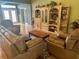 Cozy living room with hardwood floors and a decorative cabinet with a view of the front entrance at 12752 Se 91St Terrace Rd, Summerfield, FL 34491