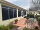 Enclosed sunroom, accessible from a tiled patio with chairs and plants at 12752 Se 91St Terrace Rd, Summerfield, FL 34491