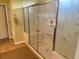 A glass enclosed shower features a built-in seat and decorative leafy pattern at 12752 Se 91St Terrace Rd, Summerfield, FL 34491