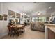 Dining area with chandelier is filled with light and adjacent to living room and sunroom at 13424 Se 89Th Terrace Rd, Summerfield, FL 34491