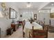 Spacious dining room with a large table, tiled floors, and plenty of natural light at 13424 Se 89Th Terrace Rd, Summerfield, FL 34491