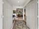 View of the foyer with an antique chair and decorative rug, with a glimpse into other rooms at 13424 Se 89Th Terrace Rd, Summerfield, FL 34491