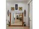 Hallway featuring neutral tile flooring, large framed mirror and decoratively adorned wall space at 13424 Se 89Th Terrace Rd, Summerfield, FL 34491