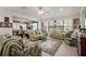 Spacious living room with multiple seating areas and ample natural light creates an inviting and comfortable atmosphere at 13424 Se 89Th Terrace Rd, Summerfield, FL 34491