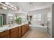 View of the main bathroom featuring a large mirror over the double sink and a separate shower and tub at 13424 Se 89Th Terrace Rd, Summerfield, FL 34491