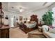 View of the main bedroom showcasing tray ceiling, ceiling fan, and ornate wood bed frame at 13424 Se 89Th Terrace Rd, Summerfield, FL 34491