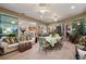 Sunroom showcasing dining and living space with sliding glass doors and tile flooring at 13424 Se 89Th Terrace Rd, Summerfield, FL 34491