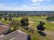 Scenic view of a manicured golf course community with lush greenery and beautiful homes under a blue sky at 13544 Se 89Th Terrace Rd, Summerfield, FL 34491