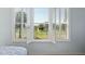 Bedroom with large window view of the golf course with shutters on window at 13544 Se 89Th Terrace Rd, Summerfield, FL 34491