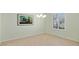 Sunlit empty room with tiled floors, neutral paint, crown molding, and plantation shutters at 13544 Se 89Th Terrace Rd, Summerfield, FL 34491