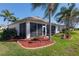 Exterior view of home with screened-in lanai and landscaped yard in a golf course community at 13544 Se 89Th Terrace Rd, Summerfield, FL 34491