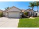 Charming single Gathering home with attached two car garage, manicured lawn, and mature landscaping at 13544 Se 89Th Terrace Rd, Summerfield, FL 34491