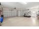 Spacious three-car garage featuring ample storage space and a golf cart at 13544 Se 89Th Terrace Rd, Summerfield, FL 34491