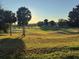 Scenic view of a meticulously maintained golf course with mature trees and manicured greens at 13544 Se 89Th Terrace Rd, Summerfield, FL 34491