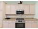 Updated kitchen with granite counters, stainless steel appliances, stone backsplash, and light wood cabinets at 13544 Se 89Th Terrace Rd, Summerfield, FL 34491