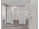 Hallway featuring several doorways and wood-look flooring at 14386 Sw 26Th Ln, Ocala, FL 34481