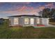 Charming single-story home featuring a well-manicured lawn, an attached garage, and a freshly painted exterior at 15487 Sw 27 Ln, Ocala, FL 34481