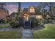 Charming two-story home featuring a symmetrical roof, complimented by a cozy front porch with inviting steps and lush shrubbery at 1621 Ne 2Nd St # 601, Ocala, FL 34470