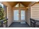 Inviting front entryway with double doors, triangular transom window, and a dark wooden deck with decorative railings at 1621 Ne 2Nd St # 601, Ocala, FL 34470