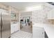 Bright kitchen featuring white cabinets, stainless steel appliances, and an open view to the living area at 1621 Ne 2Nd St # 601, Ocala, FL 34470