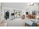 Bright, airy living room featuring vaulted ceilings, a ceiling fan, and sliding glass doors opening to the outdoors at 1621 Ne 2Nd St # 601, Ocala, FL 34470