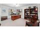 Spacious office with a wooden desk, bookshelf, two windows and a view of the outside landscape at 1621 Ne 2Nd St # 601, Ocala, FL 34470